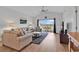 Comfortable living room with plush seating, wood floors, and sliding doors leading to an outdoor balcony at 4811 Orchid Way # 301, Myrtle Beach, SC 29577