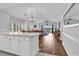 Open-concept living room and dining area with hardwood floors and a vaulted ceiling showcasing natural light at 4811 Orchid Way # 301, Myrtle Beach, SC 29577