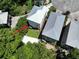 Aerial view of the house with its backyard deck and outdoor kitchen, surrounded by lush greenery at 52 Fish Shack Alley, Murrells Inlet, SC 29576