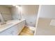 Bathroom featuring a double sink vanity, two mirrors, brushed nickel fixtures, and wood-style flooring at 52 Fish Shack Alley, Murrells Inlet, SC 29576