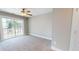 Bedroom with sliding glass doors to deck, plush carpet, and neutral gray walls at 52 Fish Shack Alley, Murrells Inlet, SC 29576