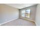 Bright bedroom featuring neutral carpeting, and double windows for natural light at 52 Fish Shack Alley, Murrells Inlet, SC 29576