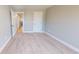 Spacious bedroom with neutral carpet, white trim, and a view of a hallway with wood-look flooring at 52 Fish Shack Alley, Murrells Inlet, SC 29576