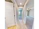 Hallway featuring wood floors leading to carpeted rooms, with neutral gray wall color throughout at 52 Fish Shack Alley, Murrells Inlet, SC 29576