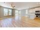 Bright living room with a ceiling fan, hardwood floors, and a view into the kitchen at 52 Fish Shack Alley, Murrells Inlet, SC 29576