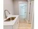 The mudroom features a sink with white cabinets and a bright adjacent room at 52 Fish Shack Alley, Murrells Inlet, SC 29576