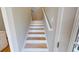 Straight staircase featuring natural wood treads, white risers and handrail, and light gray walls at 52 Fish Shack Alley, Murrells Inlet, SC 29576