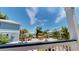 View of the street with palm trees, blue sky and neighborhood houses at 52 Fish Shack Alley, Murrells Inlet, SC 29576