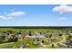 Aerial view of a residential area featuring houses with green lawns and nearby farmland at 520 Winged Elm St., Loris, SC 29569