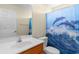 Bathroom with a single sink, neutral walls, a dolphin-themed shower curtain, and a toilet at 520 Winged Elm St., Loris, SC 29569