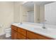 Bathroom featuring double sinks, wooden cabinets, and a shower at 520 Winged Elm St., Loris, SC 29569