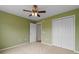 Green bedroom featuring a closet and neutral carpet with views into the hallway and doorway at 520 Winged Elm St., Loris, SC 29569