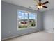 This is a bedroom with carpet and light gray walls with a large window offering plenty of natural light at 520 Winged Elm St., Loris, SC 29569