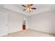 Bedroom with a ceiling fan, neutral carpet, and an open bathroom at 520 Winged Elm St., Loris, SC 29569