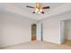 Bedroom featuring neutral carpet, a ceiling fan, and access to the bathroom and another room at 520 Winged Elm St., Loris, SC 29569