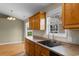 Functional kitchen showcases wood cabinets, modern faucet, and view of adjacent dining area at 520 Winged Elm St., Loris, SC 29569