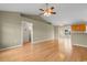 Spacious living room with hardwood floors, a ceiling fan and adjoining kitchen at 520 Winged Elm St., Loris, SC 29569