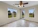 Bright sunroom with tile flooring, lots of windows, and a ceiling fan at 520 Winged Elm St., Loris, SC 29569