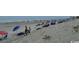 A sandy beach with people enjoying the sun and surf at 5409 N Ocean Blvd. # 111, North Myrtle Beach, SC 29582