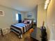 Comfortable bedroom with a queen bed featuring striped bedding and a bright blue curtain at 5409 N Ocean Blvd. # 111, North Myrtle Beach, SC 29582