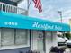 Close-up of a building entrance under a blue awning with the name 'Hartford Inlet' and building number at 5409 N Ocean Blvd. # 111, North Myrtle Beach, SC 29582