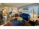 Bright living room featuring a blue sofa, area rug, kitchen, and entertainment area, creating a welcoming space at 5409 N Ocean Blvd. # 111, North Myrtle Beach, SC 29582