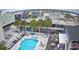 Birds eye view of a sparkling pool area with palm trees, lounge chairs and surrounding buildings at 5409 N Ocean Blvd. # 111, North Myrtle Beach, SC 29582