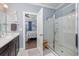 Modern bathroom with a single sink vanity, glass shower, and an open doorway to the bedroom at 5475 Elba Way # 1601, Myrtle Beach, SC 29579