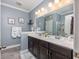 Well-lit bathroom with double sinks, modern vanity, large mirror, and a glass-enclosed shower at 5475 Elba Way # 1601, Myrtle Beach, SC 29579
