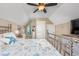 Comfortable bedroom with beach-themed decor, vaulted ceiling and an open doorway at 5475 Elba Way # 1601, Myrtle Beach, SC 29579