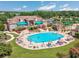 Aerial view of the sparkling community pool with lounge chairs and lush greenery surrounding the pool at 5475 Elba Way # 1601, Myrtle Beach, SC 29579