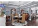 Cozy dining room featuring a round wood table, wicker chairs, elegant decor, and hardwood floors at 5475 Elba Way # 1601, Myrtle Beach, SC 29579