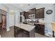 A well-equipped kitchen featuring stainless steel appliances, dark wood cabinets, a granite island, and ample countertop space at 5475 Elba Way # 1601, Myrtle Beach, SC 29579