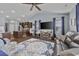 A well-lit open concept living room with a large TV, modern furniture, and wood flooring at 5475 Elba Way # 1601, Myrtle Beach, SC 29579