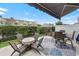 Relaxing patio space with two dining tables, a grill, and privacy hedges to ensure quiet enjoyment at 5475 Elba Way # 1601, Myrtle Beach, SC 29579
