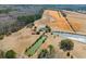 Ariel view of a private property featuring several ponds and a white house with a red barn at 589 Loop Circle, Longs, SC 29568