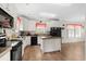 Functional kitchen with white cabinets, black appliances, and a center island for meal preparation at 589 Loop Circle, Longs, SC 29568