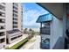 Balcony showing ocean view, with chairs and table, near the beach and other condo buildings at 6000 N Ocean Blvd. # 329, North Myrtle Beach, SC 29582