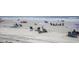 Wide angle of beach with people in beach chairs with umbrellas, and ocean view at 6000 N Ocean Blvd. # 329, North Myrtle Beach, SC 29582
