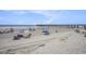 Expansive beach view of pier and families enjoying the day with umbrellas, chairs, and the ocean at 6000 N Ocean Blvd. # 329, North Myrtle Beach, SC 29582