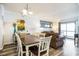 Bright dining room with a table for six and views into the living room and kitchen at 6000 N Ocean Blvd. # 329, North Myrtle Beach, SC 29582