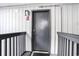 Apartment entry door with wood paneling and storm door mat at 6000 N Ocean Blvd. # 329, North Myrtle Beach, SC 29582