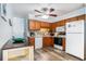 A bright kitchen with wood cabinets, white appliances, and a brick backsplash at 6000 N Ocean Blvd. # 329, North Myrtle Beach, SC 29582