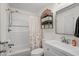 Bright bathroom featuring a tub with shower, white vanity, and towel storage shelf at 6001 - 1498 S Kings Hwy., Myrtle Beach, SC 29575