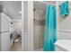 Bathroom with a tiled shower, leading to a kitchen with modern gray cabinets at 6001 - 1498 S Kings Hwy., Myrtle Beach, SC 29575