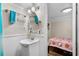 Well-lit bathroom flowing into bedroom, with a white vanity and decorative mirror at 6001 - 1498 S Kings Hwy., Myrtle Beach, SC 29575