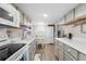 Bright kitchen featuring grey cabinets, modern appliances, and a dining area with abundant lighting at 6001 - 1498 S Kings Hwy., Myrtle Beach, SC 29575