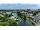 Breathtaking aerial view showcases a community with a lagoon, fountains, lush greenery, and ocean in the distance at 601 Hillside Dr. N # 3704, North Myrtle Beach, SC 29582