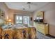 Cozy bedroom featuring a comfortable bed, dresser, and sliding glass doors to a balcony at 601 Hillside Dr. N # 3704, North Myrtle Beach, SC 29582