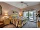Comfortable bedroom with a ceiling fan, a balcony, and neutral colors at 601 Hillside Dr. N # 3704, North Myrtle Beach, SC 29582